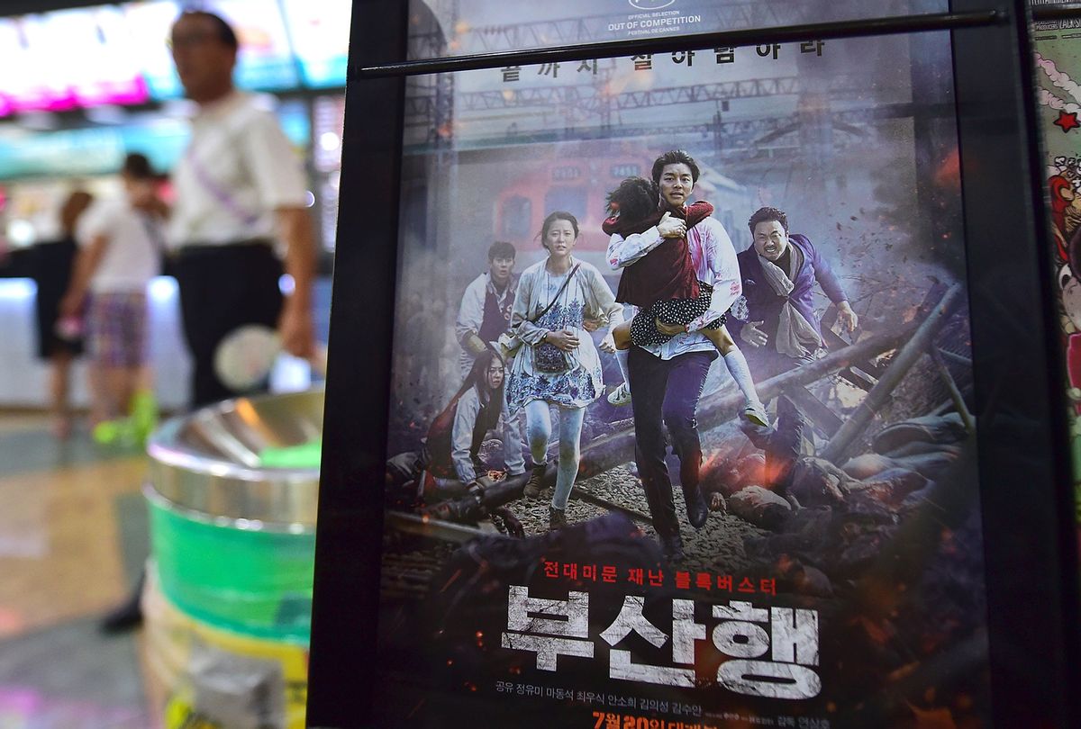 A man walks past a poster of the first South Korean zombie blockbuster, "Train to Busan," at a movie theater in Seoul on August 4, 2016. (JUNG YEON-JE/AFP via Getty Images)