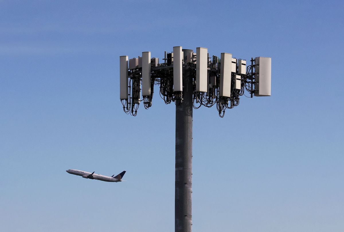 A United Airlines plane flies by a cellular tower as it takes off from San Francisco International Airport on January 18, 2022 in San Francisco, California. Verizon and AT&T announced that they will proceed with plans to activate 5G cellular service across the nation on Wednesday with the exception of near airports and runways after the Federal Aviation Administration and major airlines warned that the signal could interfere with navigational systems on some planes and cause flight disruptions. (Justin Sullivan/Getty Images)