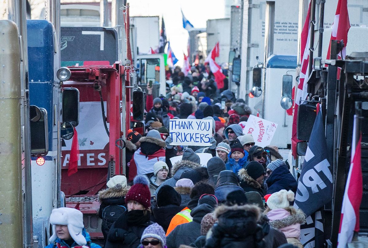 Supporters arrive at Parliament Hill for the Freedom Truck Convoy to protest against Covid-19 vaccine mandates and restrictions in Ottawa, Canada, on January 29, 2022. - Hundreds of truckers drove their giant rigs into the Canadian capital Ottawa on Saturday as part of a self-titled "Freedom Convoy" to protest vaccine mandates required to cross the US border. (LARS HAGBERG/AFP via Getty Images)