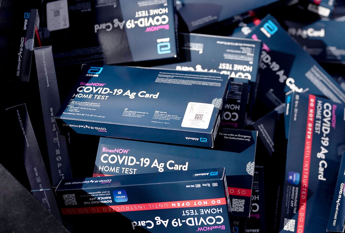COVID-19 at-home rapid test kits are given away during a drive-thru event at the Hollywood library on December 30, 2021 in Hollywood, Florida. Broward County began distributing a limited supply of the kits to residents while supplies last. The distribution started today and runs through tomorrow at drive-thru sites outside of nine county libraries. (Joe Raedle/Getty Images)