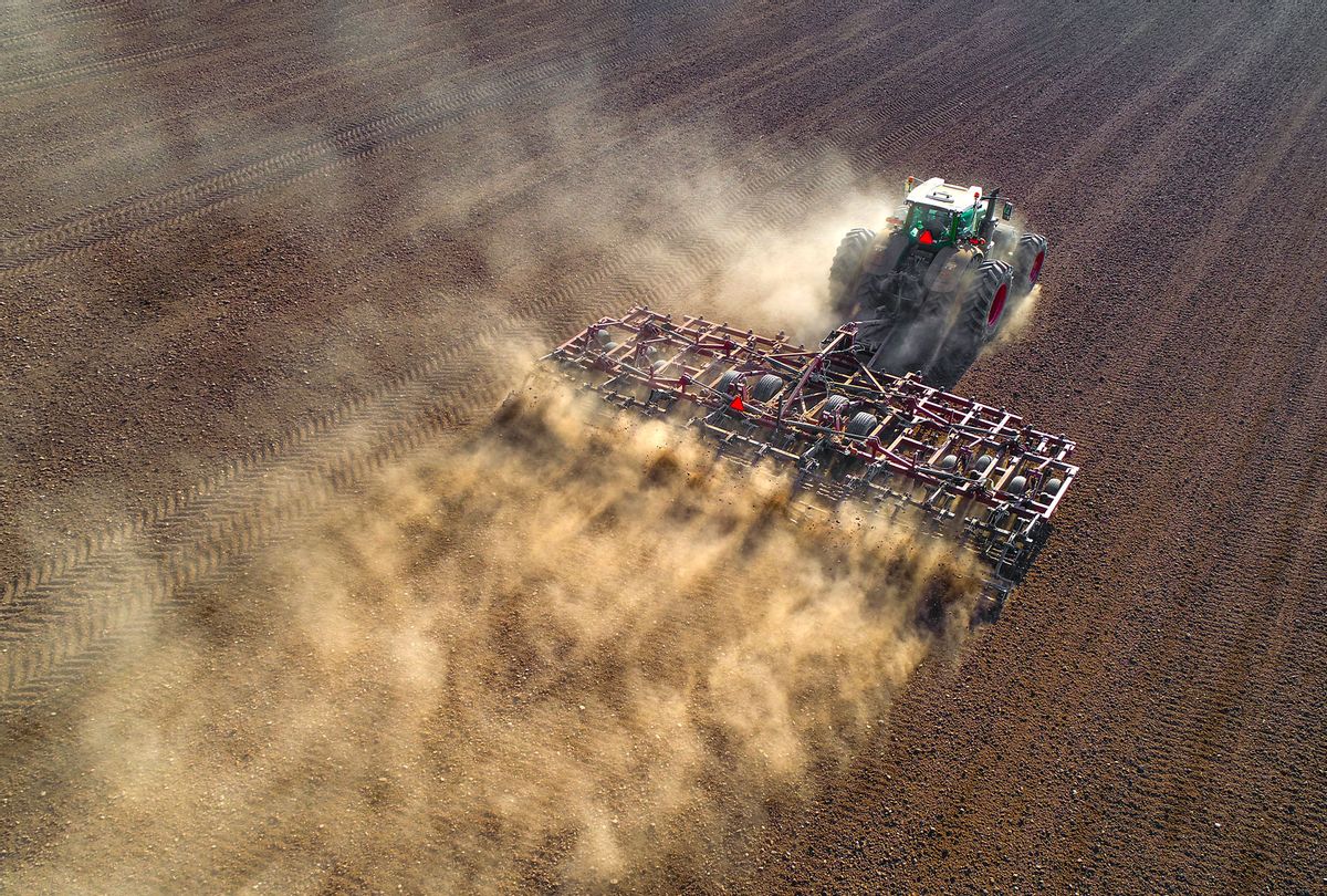 Big farm tractor tilling dusty Springtime fields (Getty Images/JamesBrey)