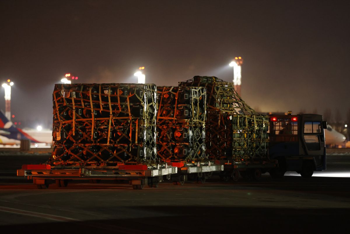 An airport vehicle pulls a shipment of weapons that include Javelin anti-tank missiles and other military hardware delivered by the U.S. military at Boryspil Airport near Kyiv, Ukraine, on Jan. 25. (Sean Gallup/Getty Images)