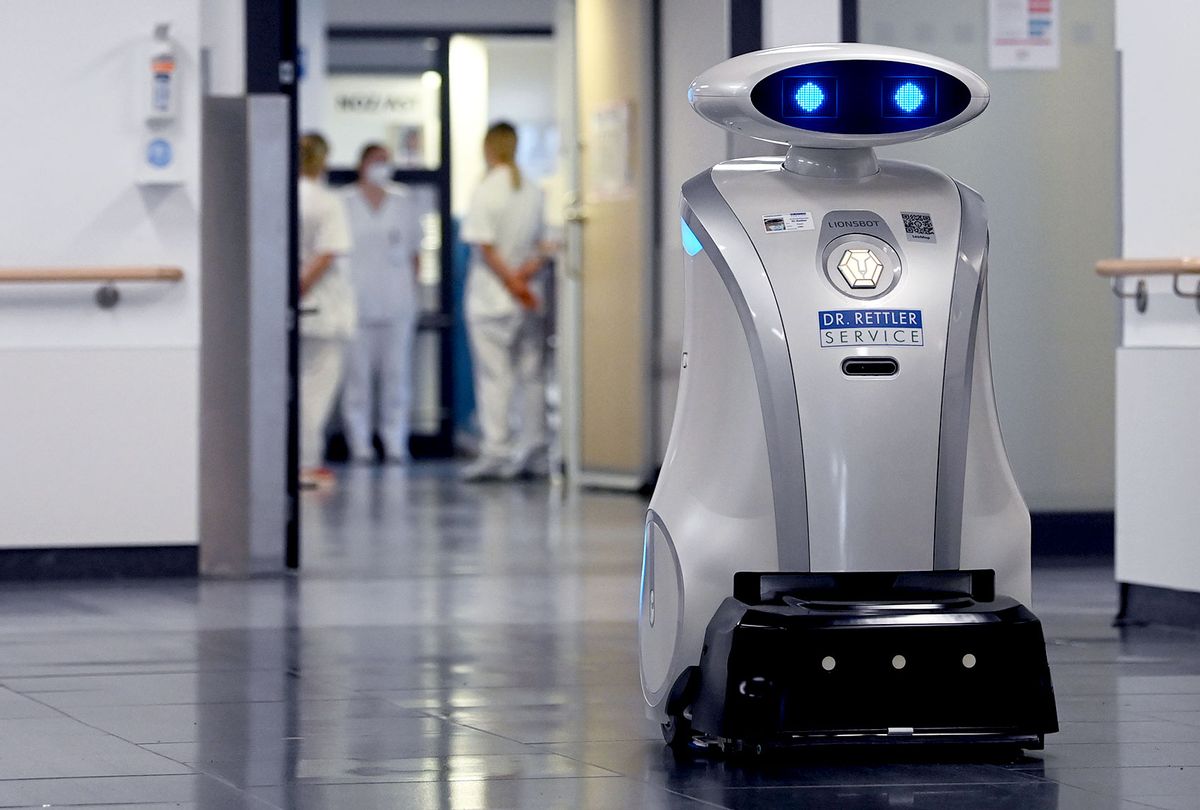 Cleaning robot 'Franzi' cleans in the entrance area of a hospital in Munich Neuperlach, southern Germany, on February 12, 2021. - Cleaning robot Franzi always makes sure the floors are spotless at the Munich hospital where she works, but she has also taken on a new role in the pandemic: cheering up patients and staff. (CHRISTOF STACHE/AFP via Getty Images)