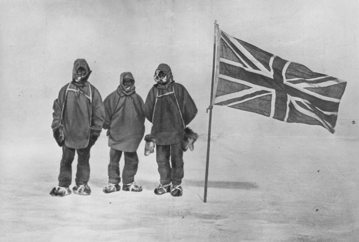 Irish explorer Sir Ernest Henry Shackleton and two members of his expedition team beside a Union Jack within 111 miles of the South Pole, a record feat, circa 1909 (Hulton Archive/Getty Images)