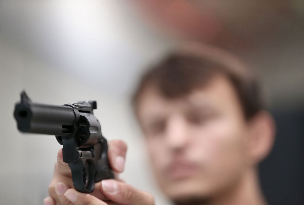 A person holds a gun (Omer Urer/Anadolu Agency via Getty Images)