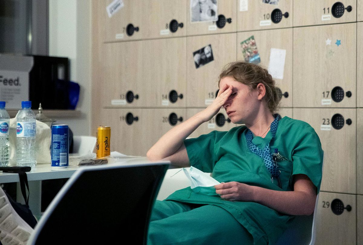 nurse, reacts to tiredness early on April 11, 2020, during her night shift in the intensive care unit exclusively for COVID-19 patients at the Ixelles Hospital in Brussels, amid the COVID-19 pandemic, caused by the novel coronavirus. (ARIS OIKONOMOU/AFP via Getty Images)
