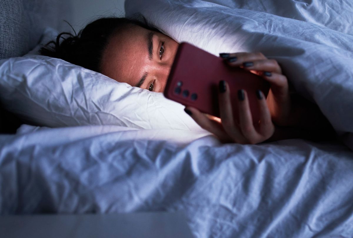 Lady on smartphone in bed (Getty Images/Sergey Mironov)