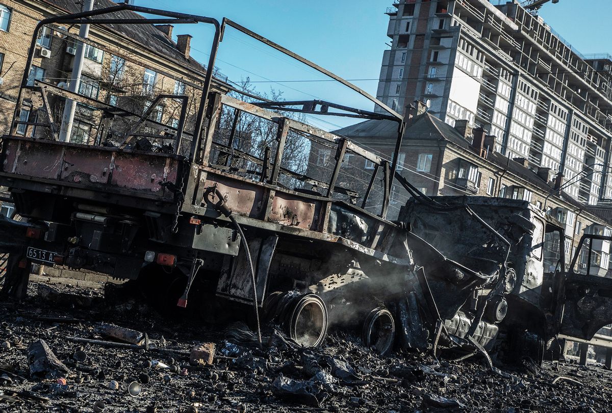 A burnt out truck allegedly belonging to a Russian commando unit on Victory Avenue on February 26,2022 in Kyiv, Ukraine. According to Ukrainian soldiers present on Victory Avenue, the Russian commandos, wearing Ukrainian uniforms, allegedly tried to advance towards the center of Kiev and was stopped by the Ukrainian forces. Explosions and gunfire were reported around Kyiv on the second night of Russia's invasion of Ukraine, which has killed scores and prompted widespread condemnation from US and European leaders. (Laurent Van der Stockt for Le Monde/Getty Images)