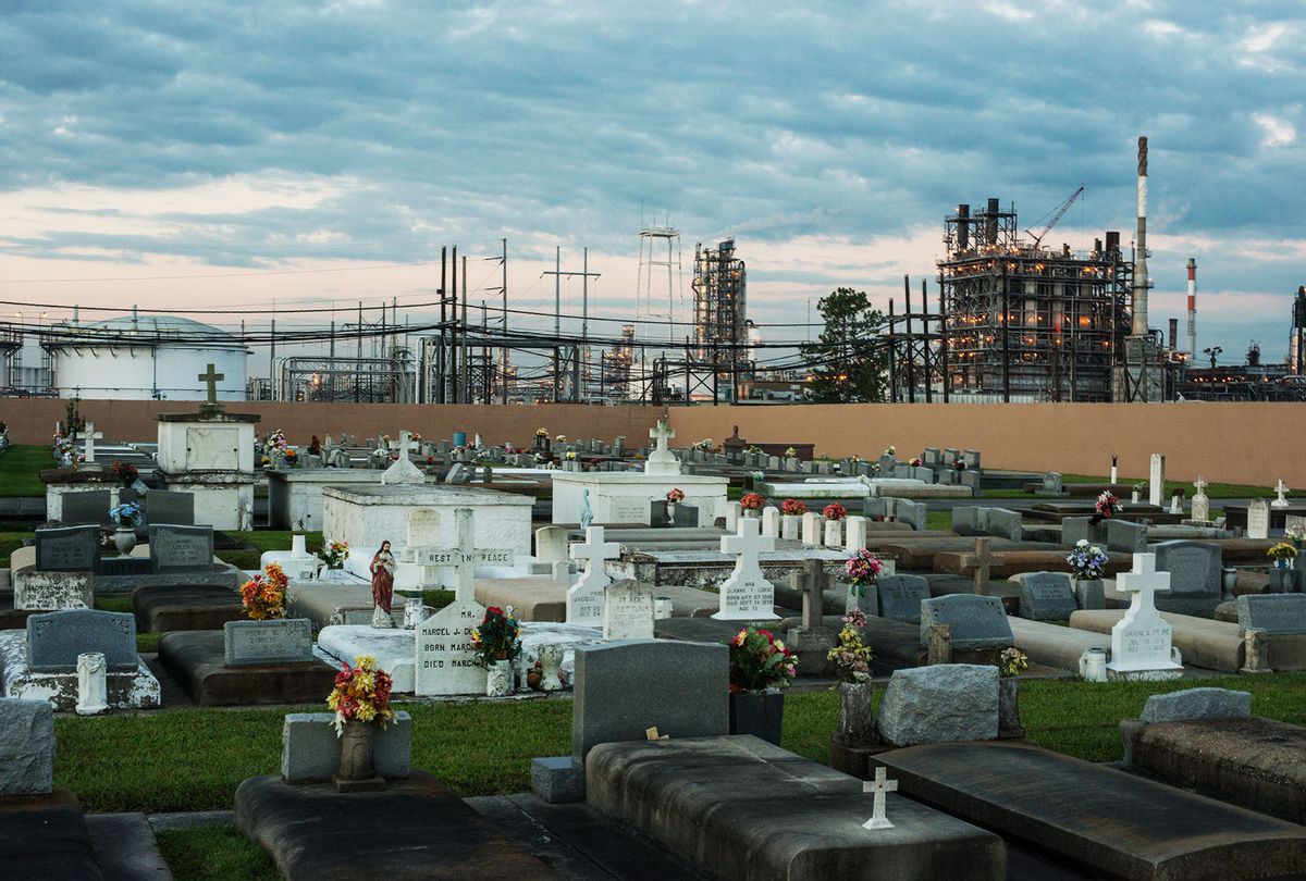 A cemetery stands in stark contrast to the chemical plants that surround it October 15, 2013. 'Cancer Alley' is one of the most polluted areas of the United States and lies along the once pristine Mississippi River that stretches some 80 miles from New Orleans to Baton Rouge, where a dense concentration of oil refineries, petrochemical plants, and other chemical industries reside alongside suburban homes. (Giles Clarke/Getty Images)