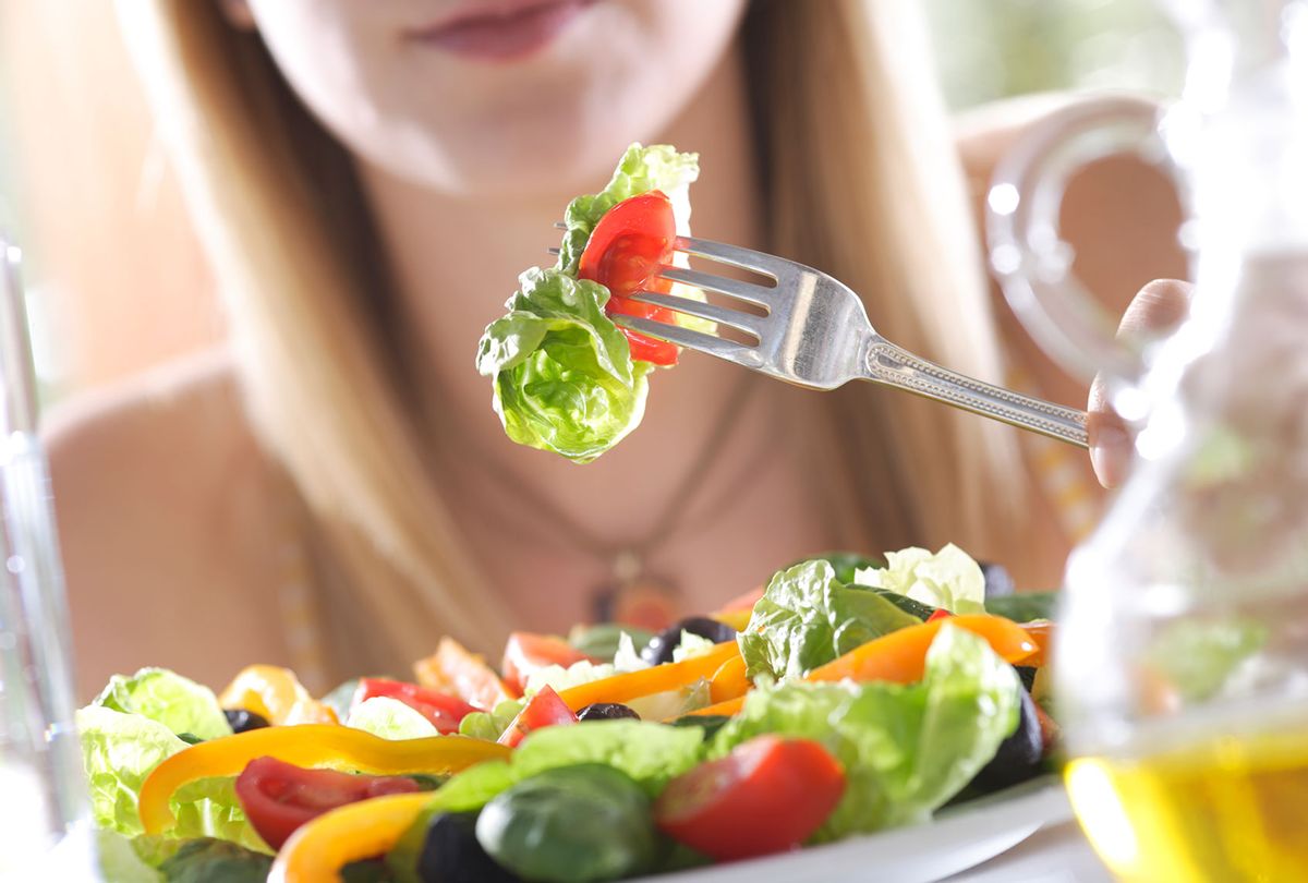 Woman eating a salad (Getty Images/Peter Cade)
