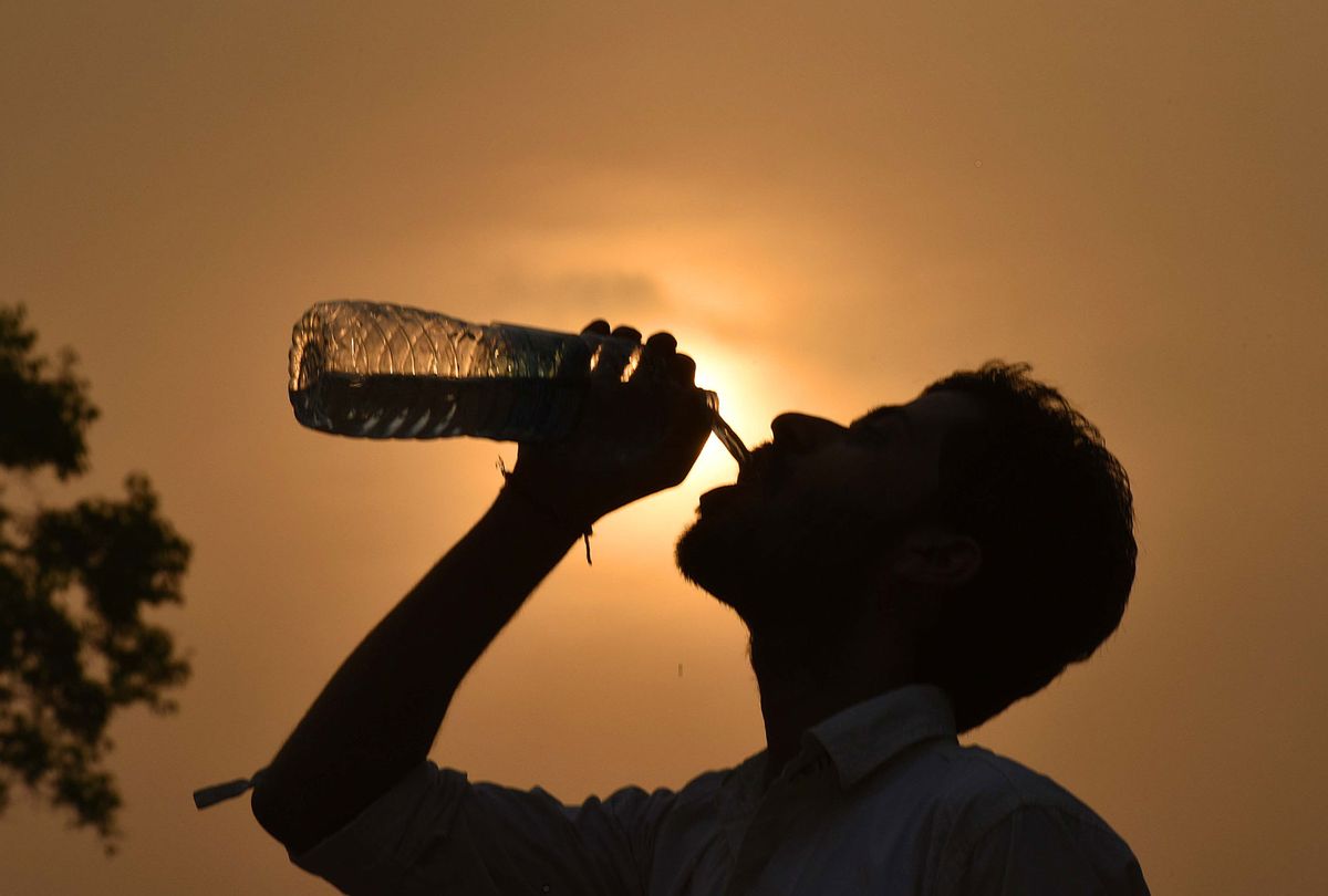 A man drinks water from the water bottle during a hot weather, as the heat wave conditions prevailed in Northern India with the maximum temperature settling at 38.9 degrees Celsius, five notches above the normal, on April 3, 2016 in New Delhi, India. (Raj K Raj/Hindustan Times via Getty Images)