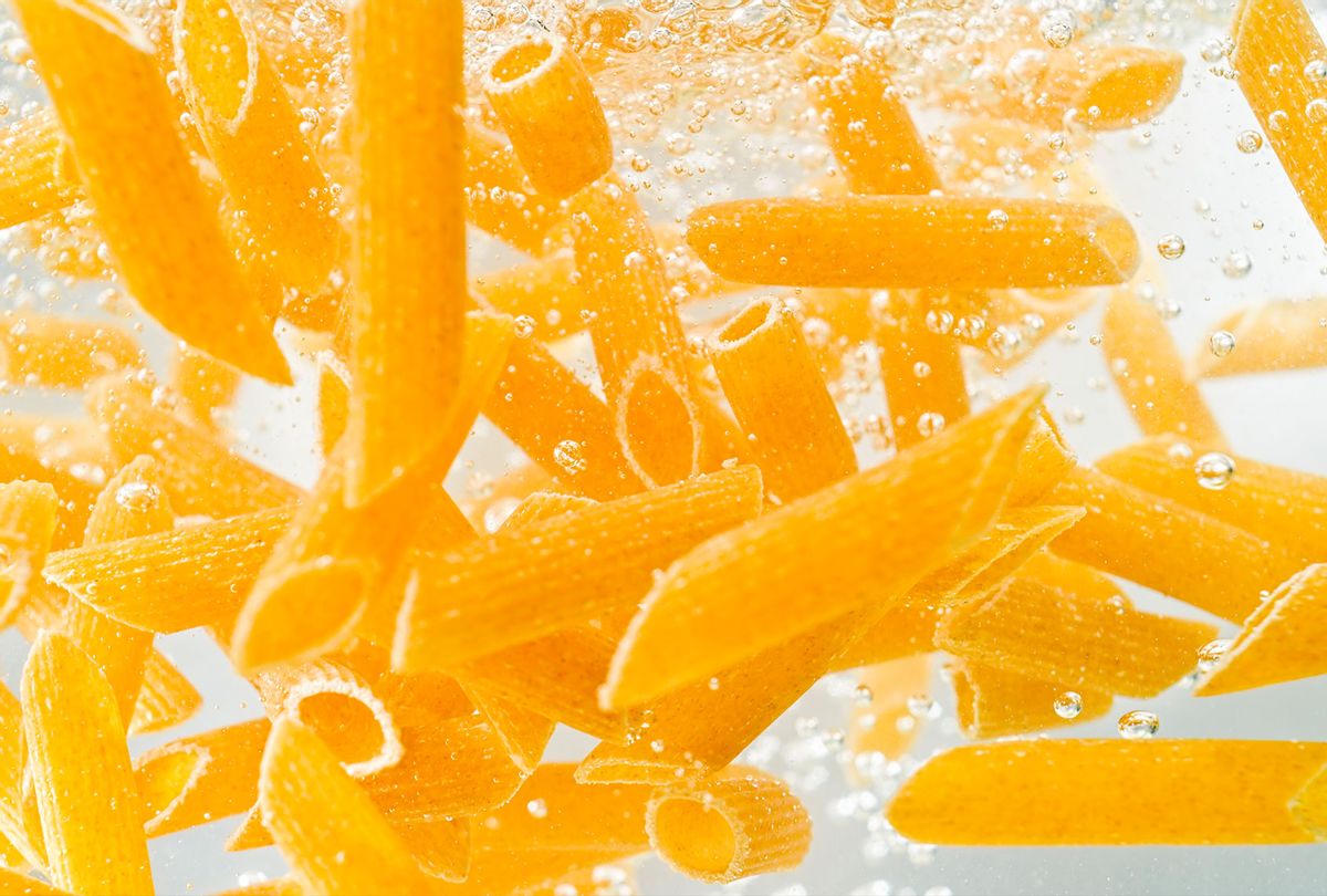 Penne pasta falling into boiling water (Getty Images/simonkr)