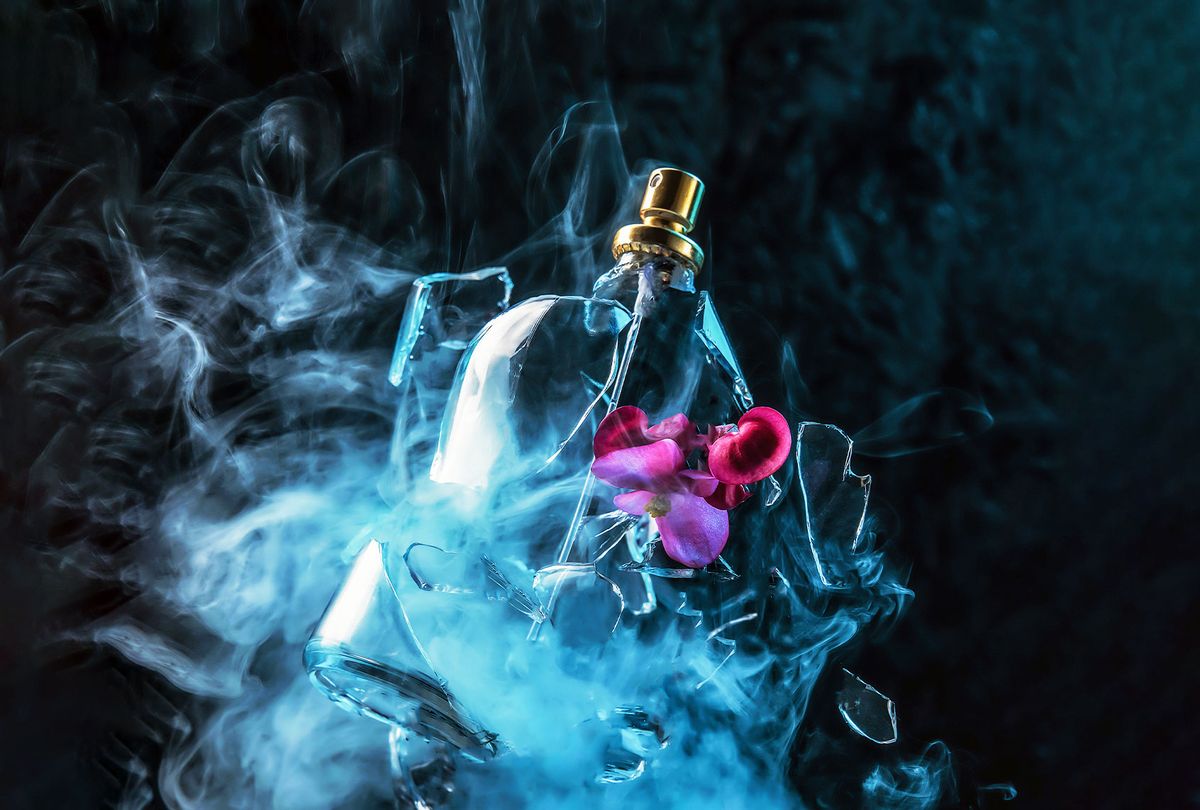 A glass perfume bottle shatters and bright spring flowers and clouds of blue and purple vapor burst out of it (Getty Images/Anton Frunze)