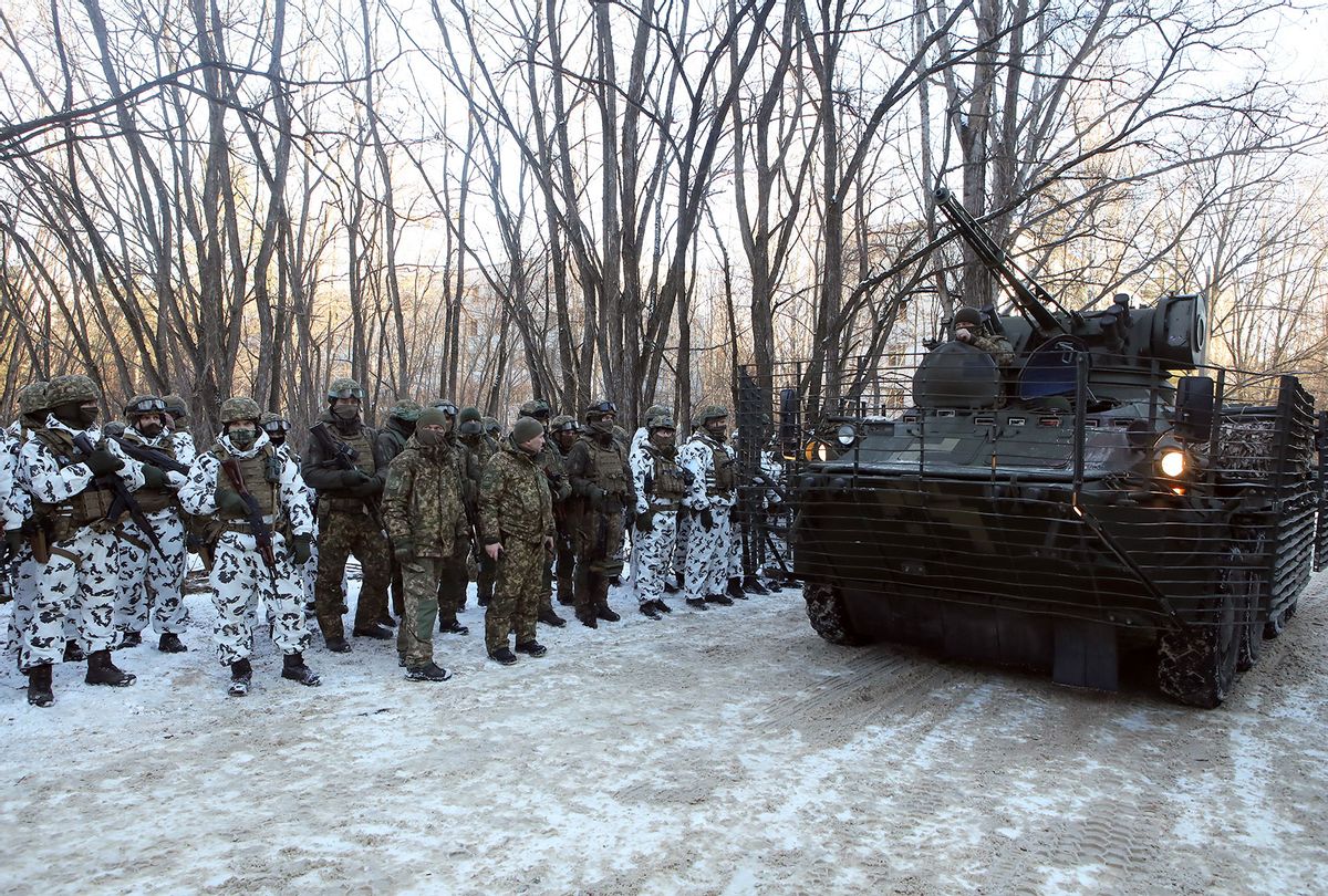 A military vehicle with spaced armour moves past servicemen during tactical drills for Ukrainian Interior Ministry units to practice interoperability while defending a city, urban combat tactics and response to the aftermath of the hostilities in a city, Prypiat, the Chornobyl Exclusion Zone, Kyiv Region, northern Ukraine. (Volodymyr Tarasov/ Ukrinform/Future Publishing via Getty Images)