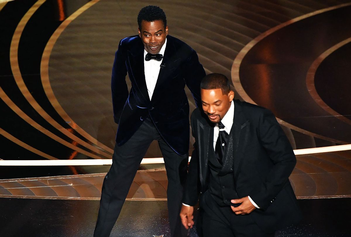US actor Will Smith (R) walks away from US actor Chris Rock onstage during the 94th Oscars at the Dolby Theatre in Hollywood, California on March 27, 2022. (ROBYN BECK/AFP via Getty Images)