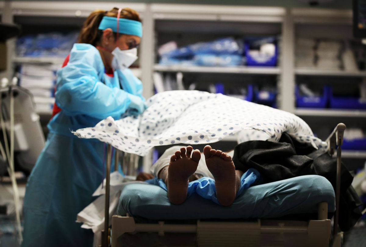 A nurse places a blanket over a patient that had just been admitted to the emergency room at Regional Medical Center on May 21, 2020 in San Jose, California. (Justin Sullivan/Getty Images)