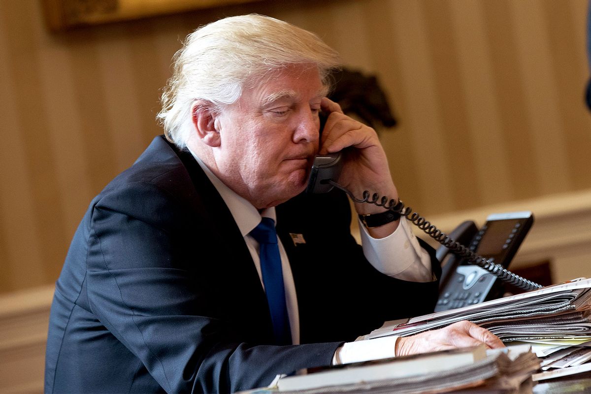 President Donald Trump speaks on the phone with Russian President Vladimir Putin in the Oval Office of the White House, January 28, 2017 in Washington, DC. On Saturday, President Trump is making several phone calls with world leaders from Japan, Germany, Russia, France and Australia. (Drew Angerer/Getty Images)