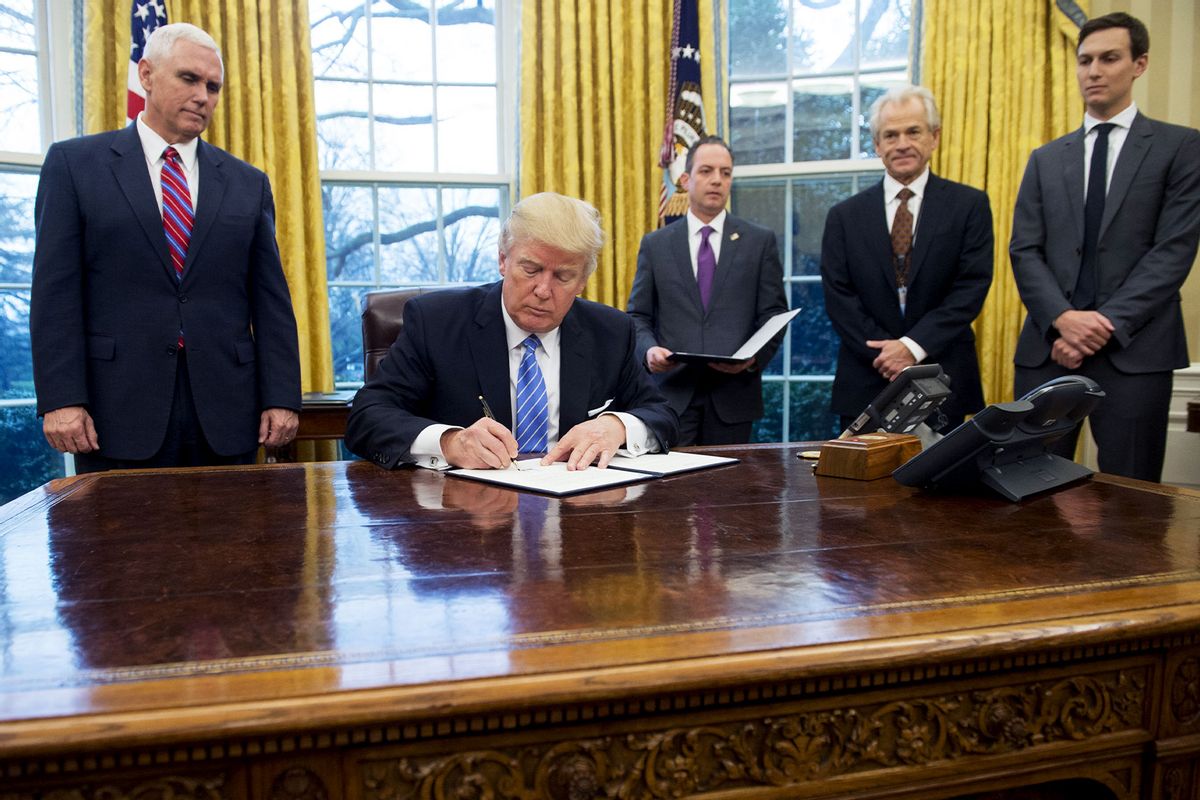 US President Donald Trump signs an executive order for a federal hiring freeze alongside White House Chief of Staff Reince Priebus, National Trade Council Advisor Peter Navarro, US Vice President Mike Pence and Senior Advisor Jared Kushner(R) in the Oval Office of the White House in Washington, DC, January 23, 2017. Trump signed the decree Monday, effectively ending US participation in a sweeping trans-Pacific free trade agreement negotiated under former president Barack Obama. (SAUL LOEB/AFP via Getty Images)