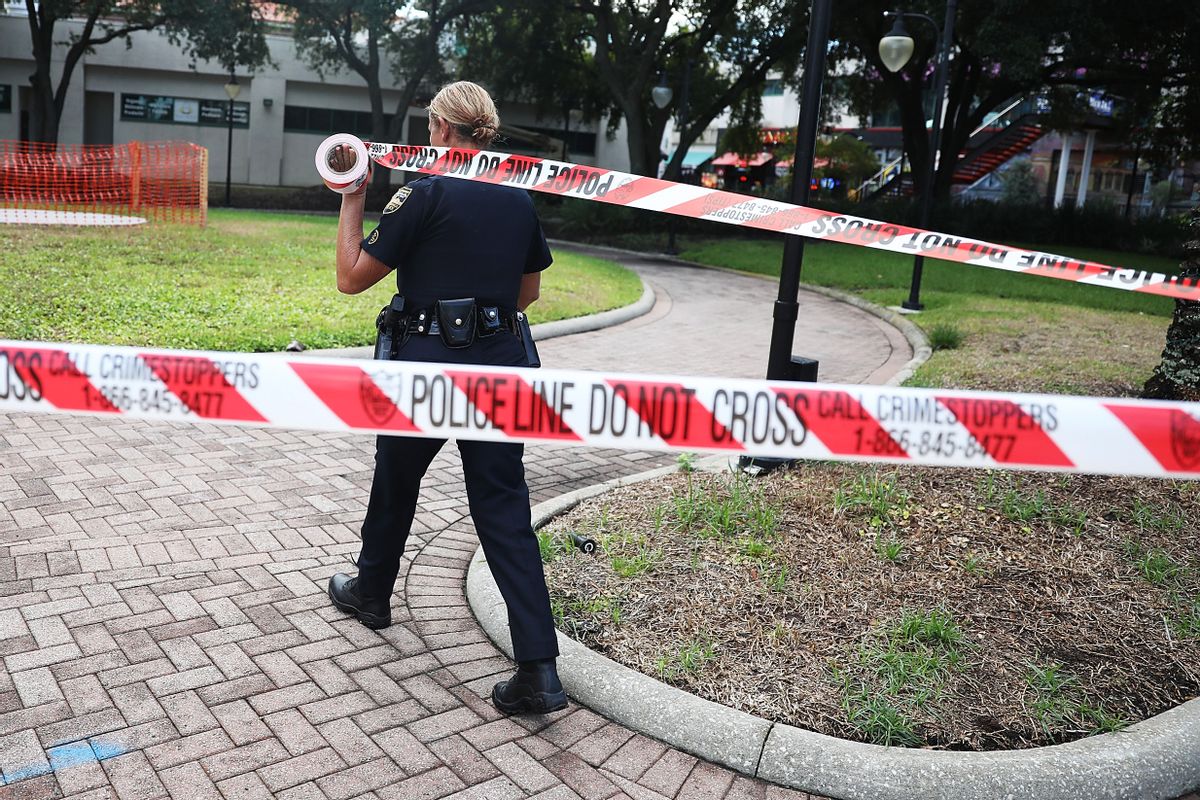 A Jacksonville Sheriff officer uses police tape to keep people out as law enforcement investigates a shooting at the GLHF Game Bar at the Jacksonville Landing on August 27, 2018 in Jacksonville, Florida. (Joe Raedle/Getty Images)