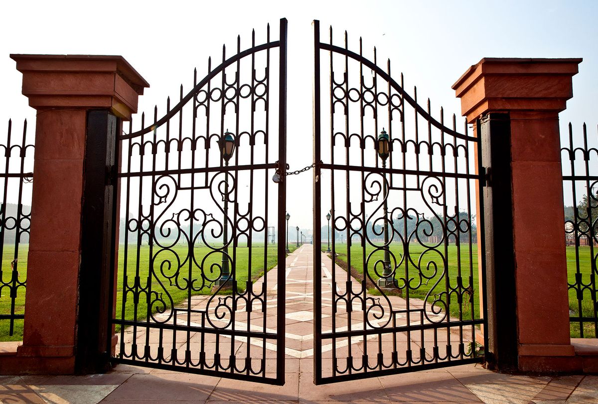 Large iron gates secured with padlock (Getty Images/Inti St Clair)