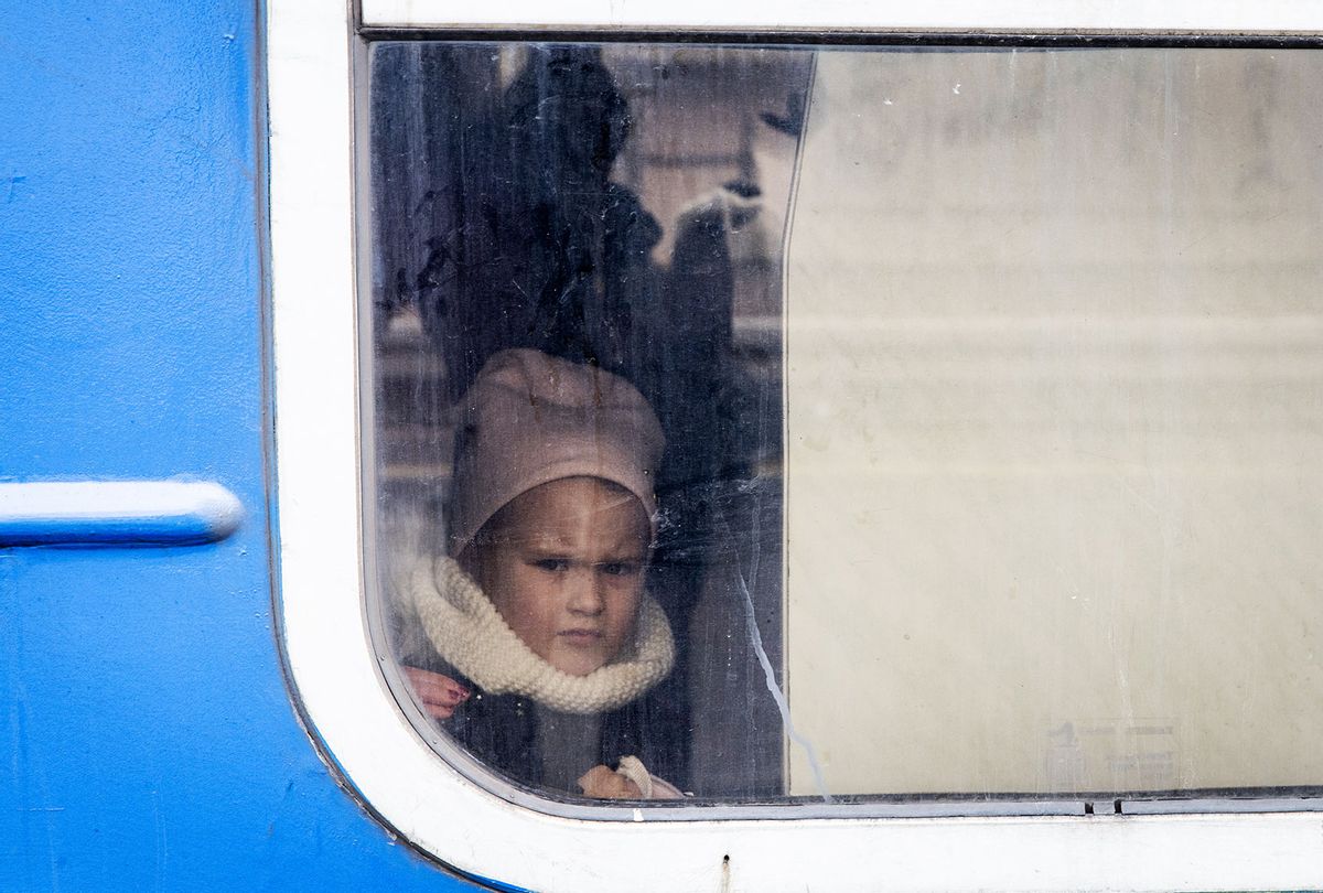 A girl looks out the train window as an evacuation train departs carrying women and children that fled fighting in Bucha and Irpin from Irpin City to Kyiv that was scheduled after heavy fighting overnight forced many to leave their homes on March 04, 2022 in Irpin, Ukraine. Russia continues assault on Ukraine's major cities, including the capital Kyiv, a week after launching a large-scale invasion of the country. (Chris McGrath/Getty Images)