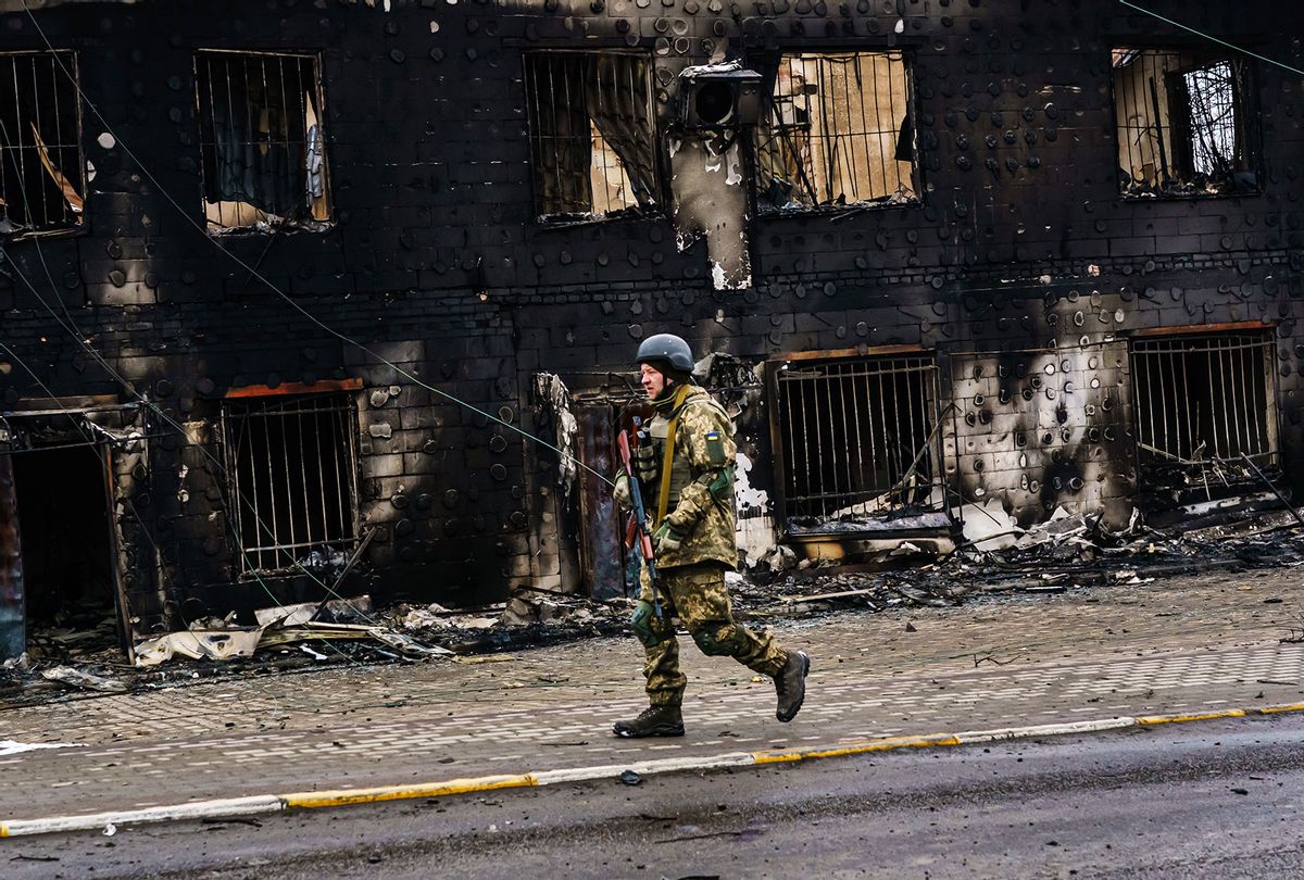 A Ukrainian soldier walks past a building that was destroyed in the midst of battle with the Russians, on the outskirts of Irpin, Ukraine, Tuesday, March 1, 2022. (Getty Images / MARCUS YAM / LOS ANGELES TIMES)