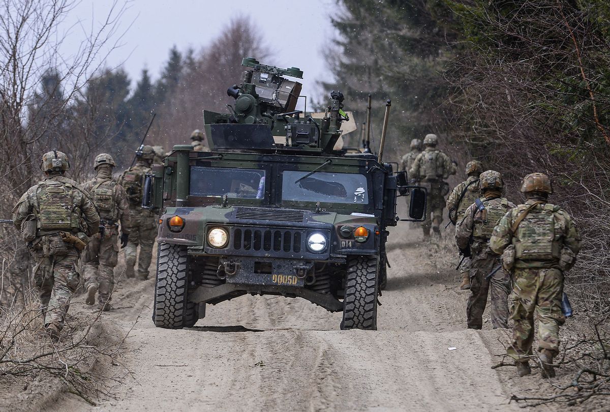 U.S. Army soldiers assigned to the 82nd Airborne carry military equipment as they take part in a exercise outside the operating base at the Arlamow Airport on , 2022 in Wola Korzeniecka, Poland. The U.S., in response to the Russian military buildup and subsequent invasion of Ukraine and in concert with other NATO member states deploying additional troops across eastern European countries, has sent thousands of troops to Poland, where they have set up bases at Rzeszow and at two small airfields, both not far from Poland's border to Ukraine. Meanwhile fighting between the Russian military and Ukrainian armed forces is raging across Ukraine. (Omar Marques/Getty Images)