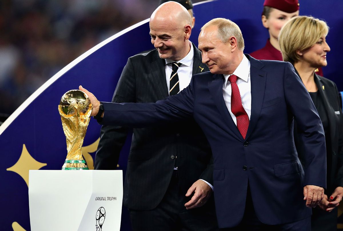 President of Russia Vladimir Putin touches the World Cup trophy after the 2018 FIFA World Cup Russia Final between France and Croatia at Luzhniki Stadium on July 15, 2018 in Moscow, Russia. (Chris Brunskill/Fantasista/Getty Images)