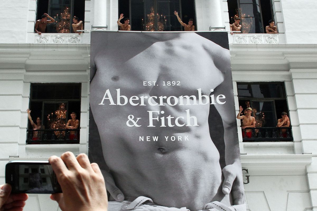 A man uses his mobile phone to take photographs of topless male models waving to a crowd of onlookers from the soon to open Abercrombie & Fitch flagship clothing store in Hong Kong on August 5, 2012. The store is due to be opened for trading on August 11. (LAURENT FIEVET/AFP/GettyImages)