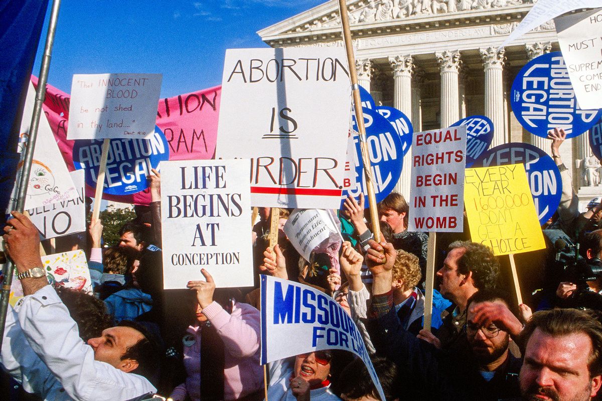 Anti-abortion and pro-choice demonstrators wave their signs outside the United States Supreme Court Building during the former group's annual March for Life, Washington DC, January 22, 1989. Among the visible signs are 'Equal Rights Begin in the Womb,' 'Life Begins at Conception,' and, on the other side of the issue, 'Keep Abortion Legal.' (Mark Reinstein/Corbis via Getty Images)