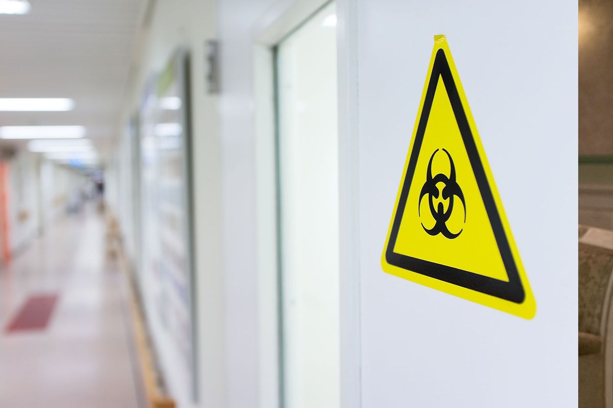A biohazard symbol on the entrance door of the microbiology laboratory (Getty Images/zmeel)