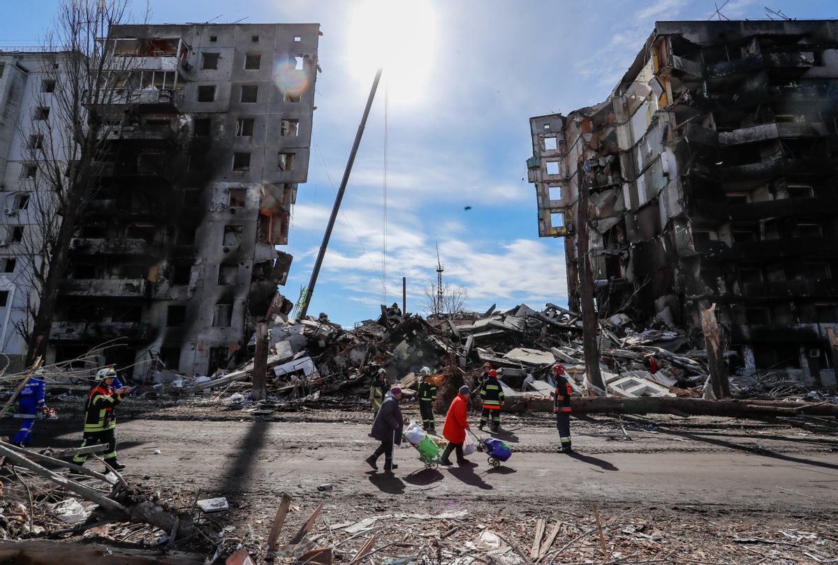 People walk past a severely damaged residential building by the Russian air raids in Borodyanka , Bucha Raion of Kyiv Oblast, on 7 April 2022. (Ceng Shou Yi/NurPhoto via Getty Images))