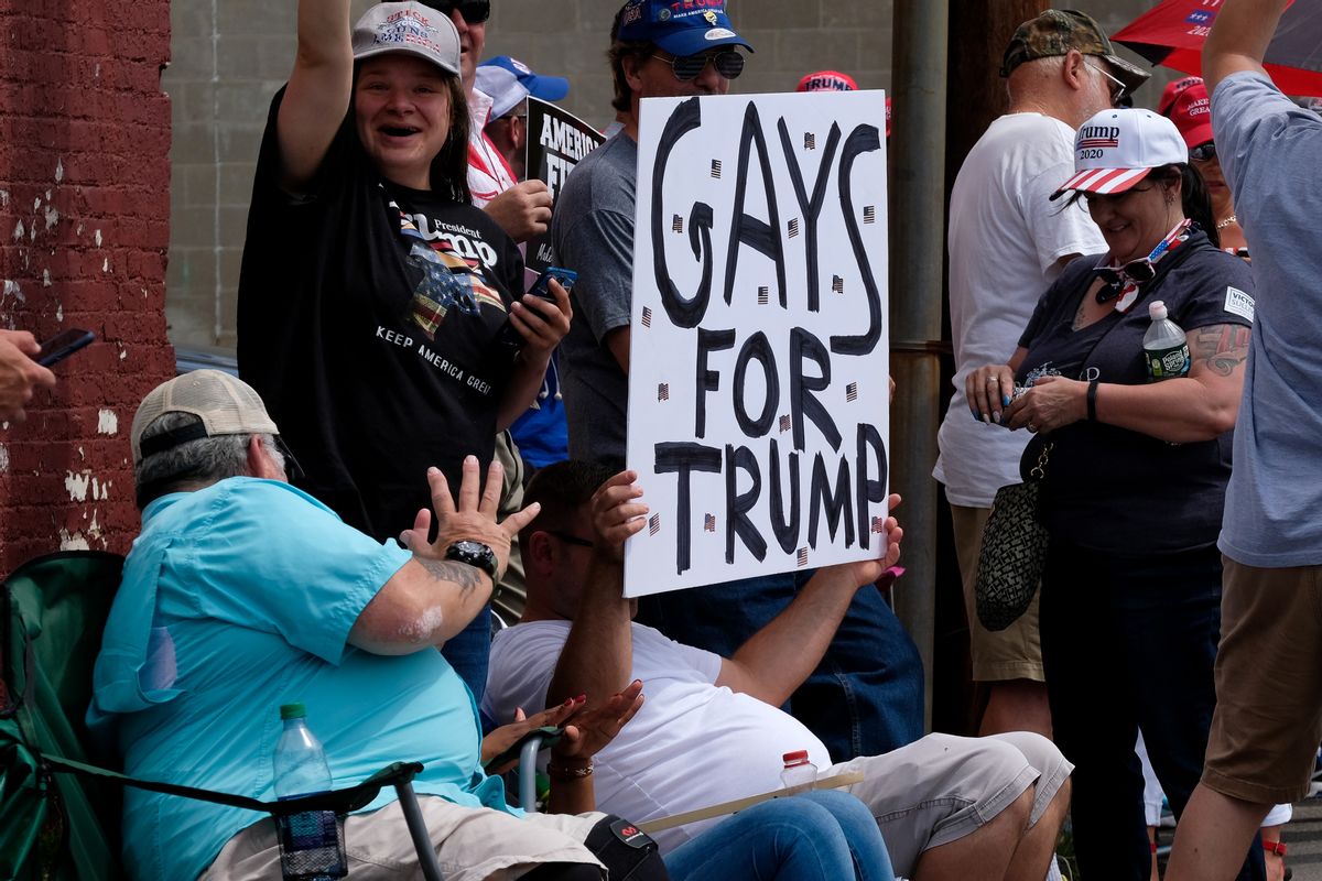 A supporter holds a placard that says gays for trump during the MAGA Rally in Manchester, New Hampshire. (Photo by Preston Ehrler/SOPA Images/LightRocket via Getty Images)
