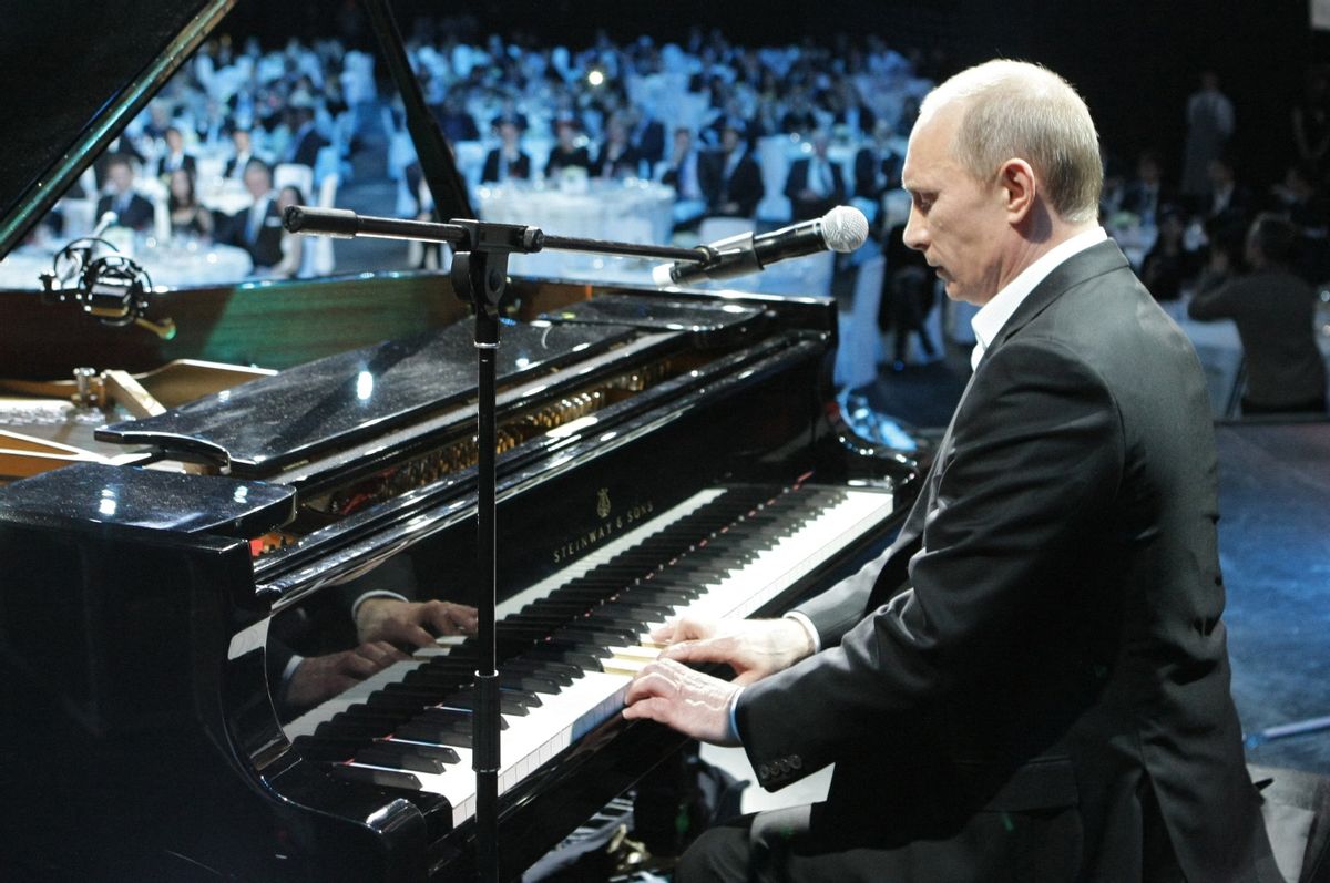 Russian Prime Minister Vladimir Putin plays piano during a charity concert in Saint Petersburg  (Photo by ALEXEY NIKOLSKY/RIA NOVOSTI/AFP via Getty Images)