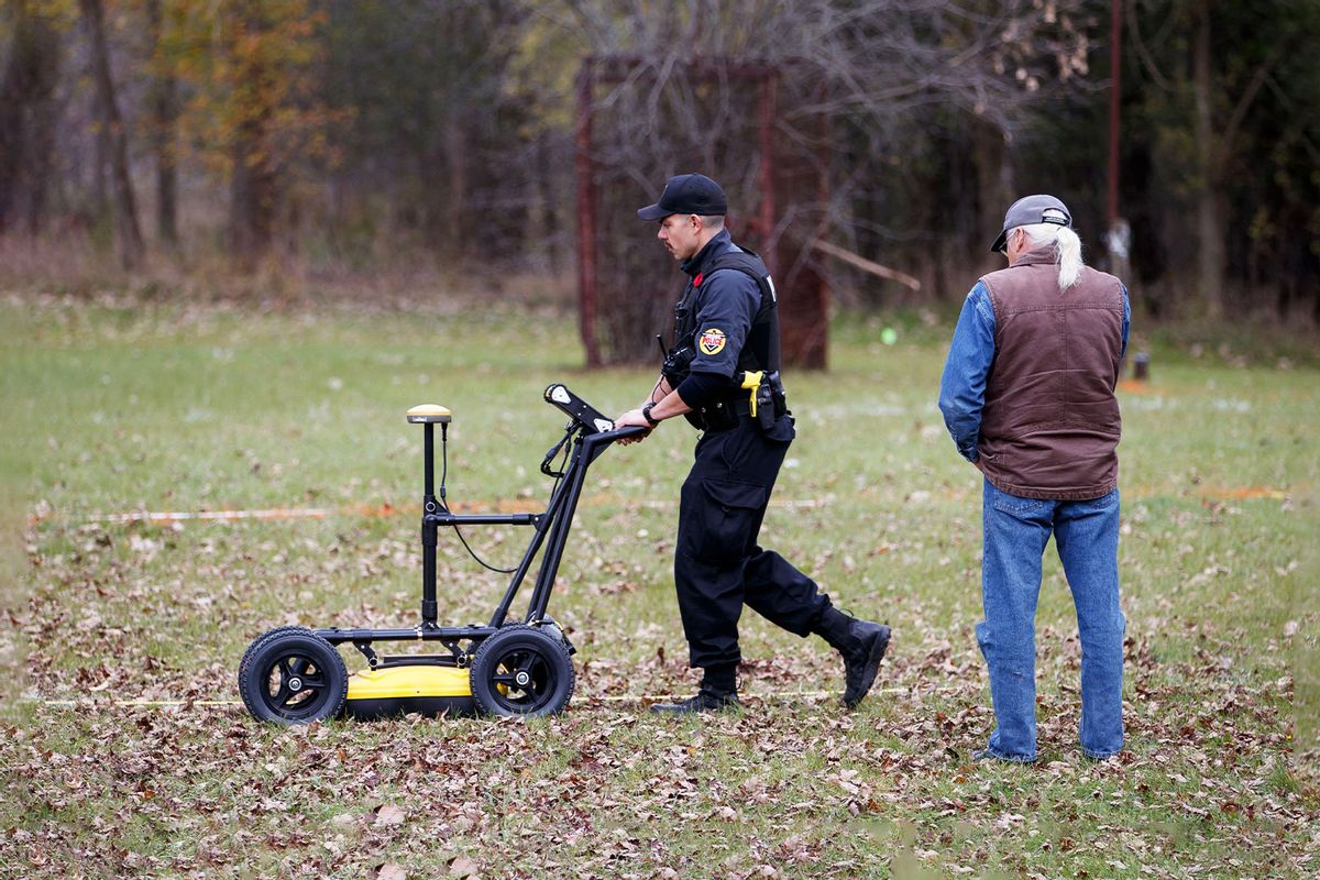 A Six Nation police officer uses a ground-penetrating radar machine on the grounds of the former Mohawk Institute Residential School, in Brantford, Canada, November 9, 2021, as the search for remains begins. - A search began Tuesday for more unmarked graves of students at one of Canada's oldest and longest-running former indigenous residential schools, near Toronto. (COLE BURSTON/AFP via Getty Images)