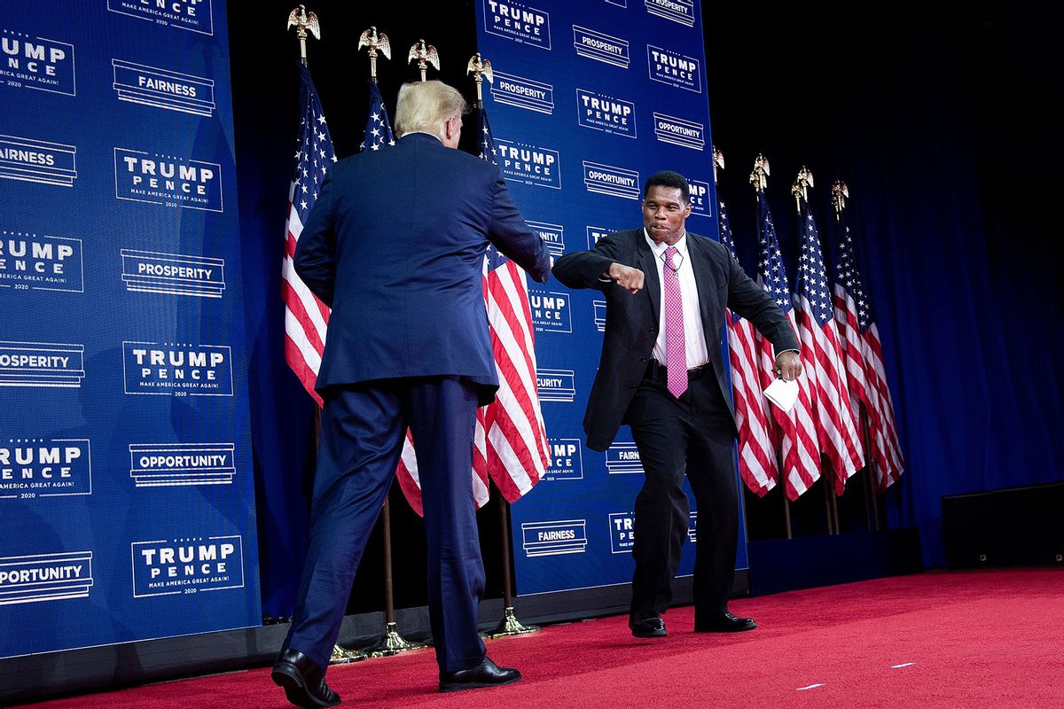 US President Donald Trump is greeted by NFL hall of fame member Herschel Walker during an event for black supporters at the Cobb Galleria Centre September 25, 2020, in Atlanta, Georgia. (BRENDAN SMIALOWSKI/AFP via Getty Images)