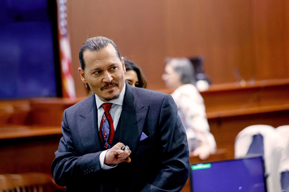Actor Johnny Depp gestures as he stands in the courtroom during a recess amid his defamation trial against his ex-wife Amber Heard, at the Fairfax County Circuit Courthouse in Fairfax, Virginia, on April 27, 2022. (JONATHAN ERNST/POOL/AFP via Getty Images)