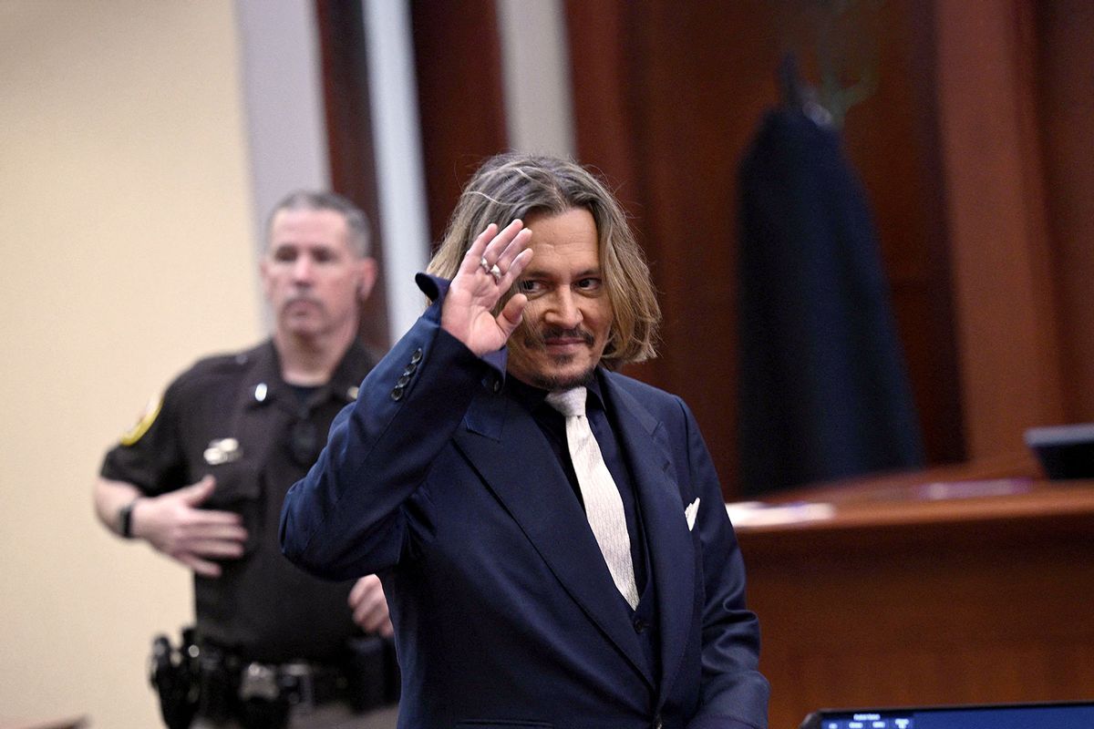 US actor Johnny Depp waves inside the courtroom during the $50 million Depp vs Heard deformation trial at the Fairfax County Circuit Court April 12, 2022, in Fairfax, Virginia. (BRENDAN SMIALOWSKI/POOL/AFP via Getty Images)