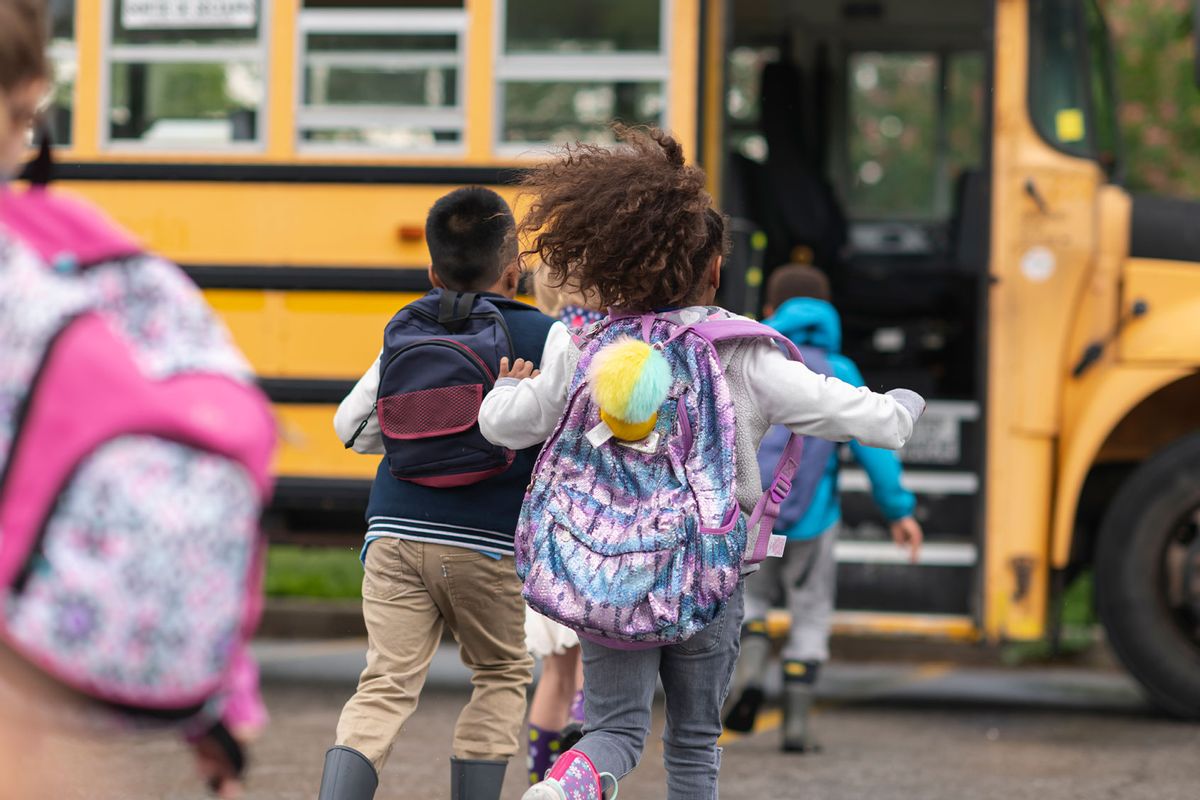 Diverse group of happy children getting on school bus (Getty Images/FatCamera)