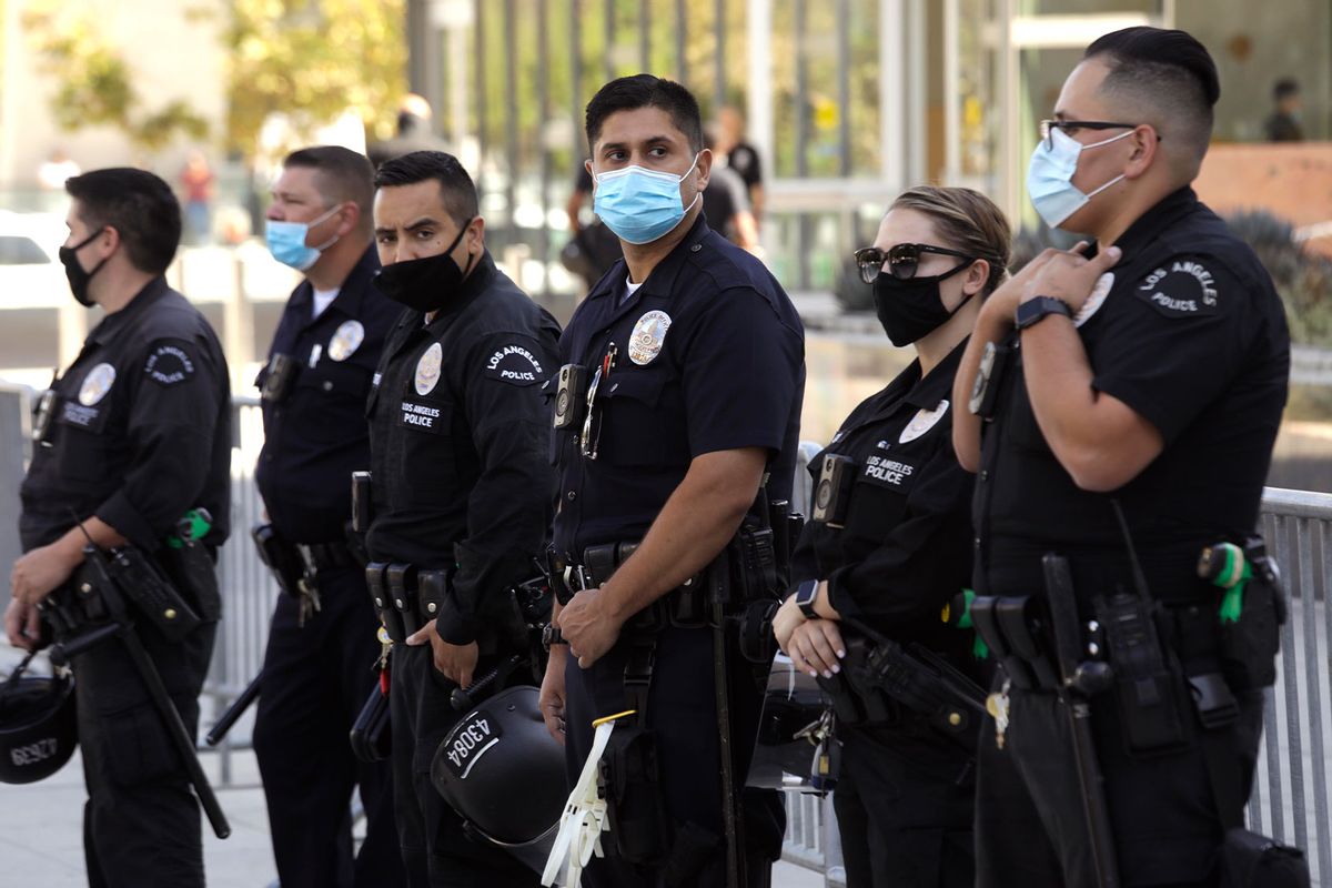 Los Angeles police officers keep an eye on an anti-vaccine protesters rally along 1st Street in front of L.A.P.D. Headquarters in downtown Los Angeles on September 18, 2021. (Genaro Molina / Los Angeles Times via Getty Images)