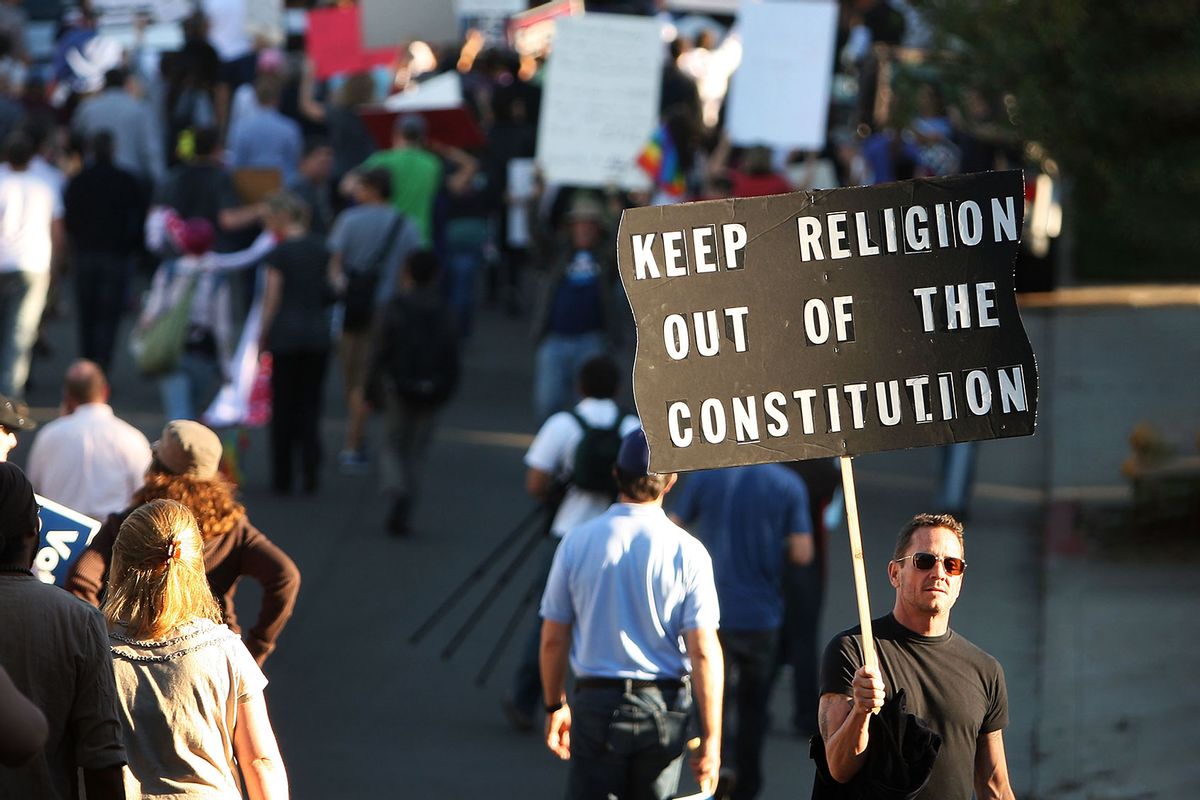 A man holding a sign reading "Keep Religion Out Of The Consitution." Hundreds of supporters of same-sex marriage march for miles in protest against the Church of Jesus Christ of Latter-day Saints November 6, 2008 in Los Angeles, California.  (David McNew/Getty Images)