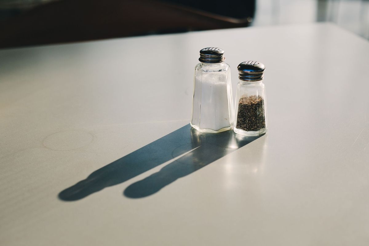 This salt shaker has one hole while the pepper shaker has multiple