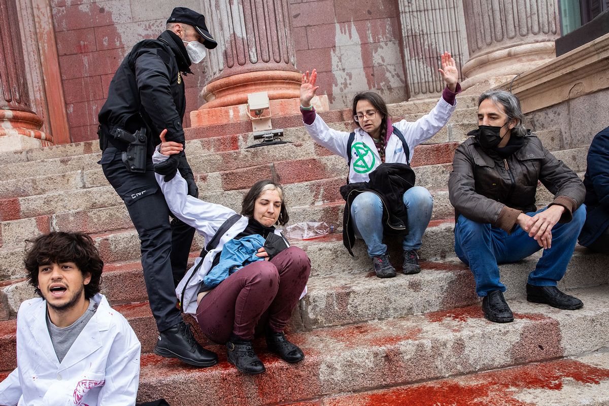 Police take protestors out during an action of Scientist Rebellion to denounce the climate situation on April 06, 2022 in Madrid, Spain. Scientists and researchers throw fake blood at the Congress of Deputies building, one of many protests planned across the globe between April 4 to 9,2022 by the international movement Scientist Rebellion. (Aldara Zarraoa/Getty Images)