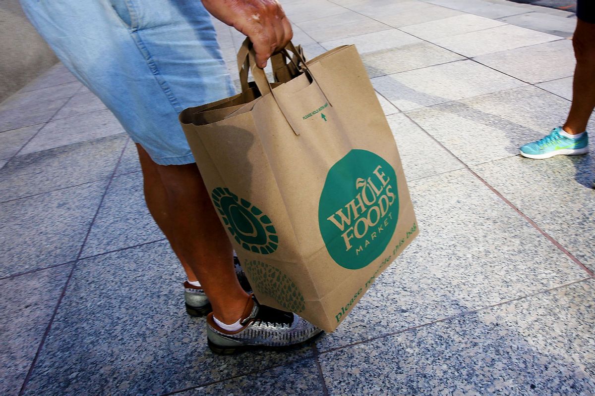 A customer carries his Whole Foods Market bag as the company appointed five new directors to its board and replaced its chairman on May 10, 2017 in Miami, Florida. (Joe Raedle/Getty Images)