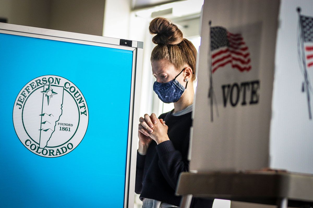 A woman says a quick prayer before turning in her ballot at Edgewater City Hall on November 3, 2020 in Edgewater, Colorado. (Marc Piscotty/Getty Images)