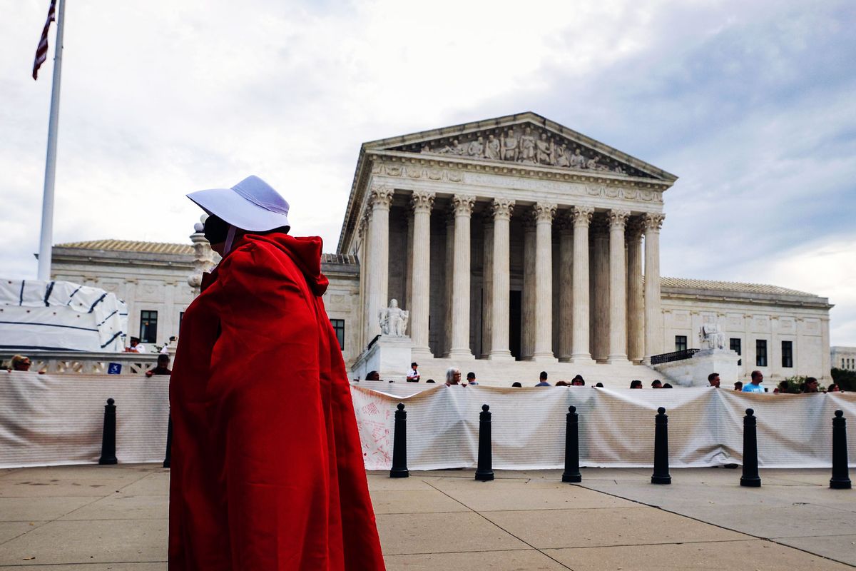A Pro-choice activist dressed in a Handmaid costume as they demonstrate outside the Supreme Court in Washington, DC.  (Kevin Dietsch/Getty Images)