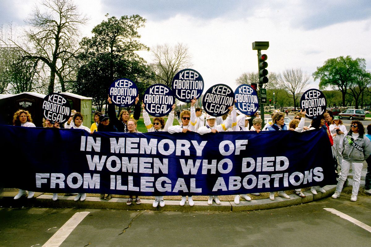 View of demonstrators as they stand behind a banner that reads 'In memory of Women Who Died from Illegal Abortions' during the March for Women's Lives demonstration, Washington DC, April 9, 1989. (Mark Reinstein/Corbis via Getty Images)
