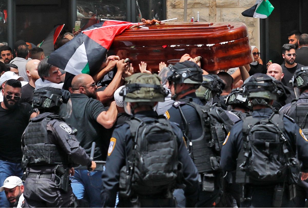 Violence erupts between Israeli security forces and Palestinian mourners carrying the casket of slain Al-Jazeera journalist Shireen Abu Akleh out of a hospital, before being transported to a church and then her resting place, in Jerusalem, on May 13, 2022. (AHMAD GHARABLI/AFP via Getty Images)