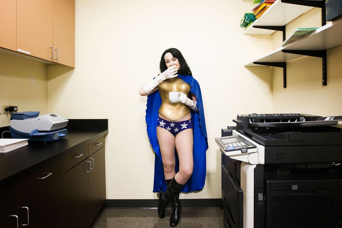 Superhero in the office break room having a snack (Getty Images/Mint Images)