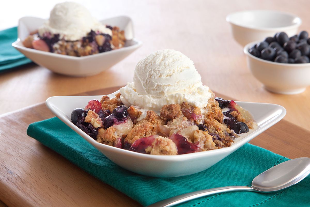 Blueberry cobblers with ice cream and extra blueberries (Getty Images/mitchellpictures)